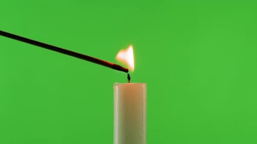 Burning Wax Candle on Green Chroma Key Background