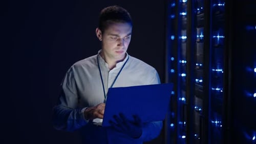 IT Technician in Data Center Digital Server Room Controlling Work of Rack Server Cabinets with a