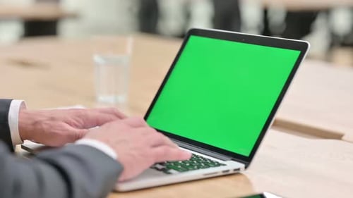Hands Typing on Laptop with Green Screen in Office