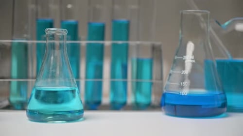 Close Up of Lab Glassware with Blue Liquids