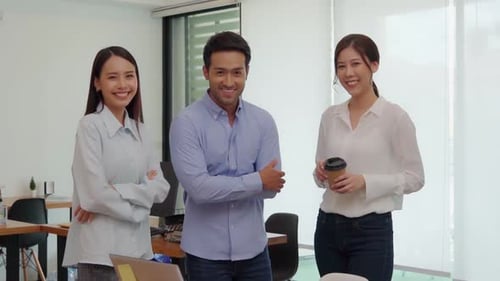 Smiling Young Professionals Standing in Modern Office