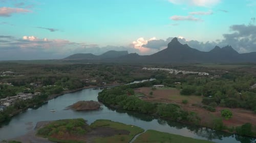 Landscape of a Pacific Island with Boats and Lagoon in Aerial View Sunset