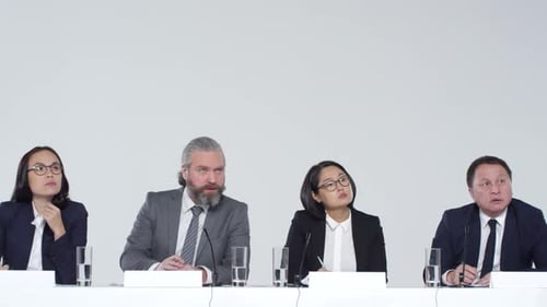 People in Suits Speak at Conference