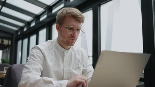 Modern Coworking Space for Freelancer and Worker Remote Adult Man is Working with Laptop in Office