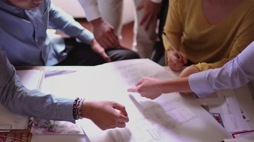 Business People working on a blueprint in the office
