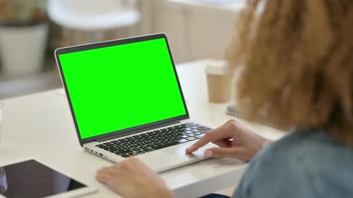 African Woman Using Laptop with Green Screen
