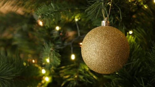 Golden shiny bauble with sequins close-up 4K 2160p 30fps UltraHD footage - Gold color Christmas orn