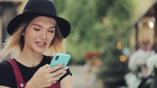 Smiling Woman Using Phone Outdoors in City