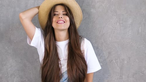 Smiling Woman Posing in Hat and Overalls