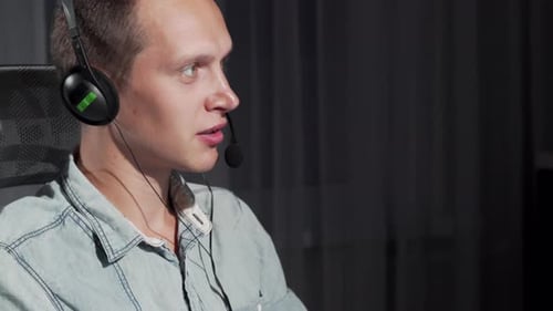 Cropped Shot of a Handsome Young Man Working at Call Center on Night Shift