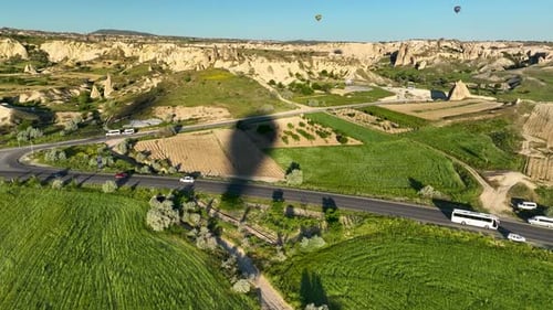 4K Aerial view of Goreme. Colorful hot air balloons fly over the valleys.