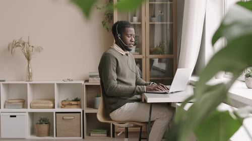 Young Adult Working Remotely From Home on Laptop