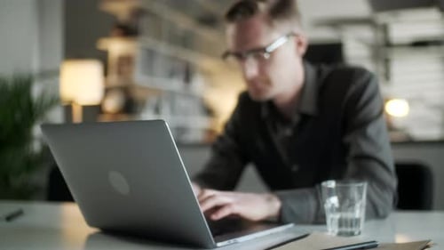 Young Man Freelancer Using Laptop Online Working From Office In Internet, Smiling Focused Millennial