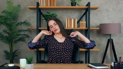 Tired business woman in home office warm up stretches body massages neck in pain rubs tense muscles