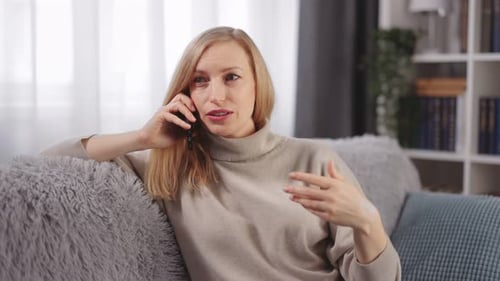 Woman Chatting on Phone in Cozy Living Room