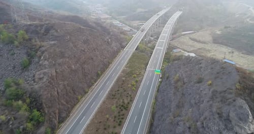Aerial View of Elevated Highway with Bridge Surrounded By Dry Mountain