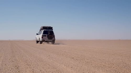 Off-road vehicle driving in the Sahara desert