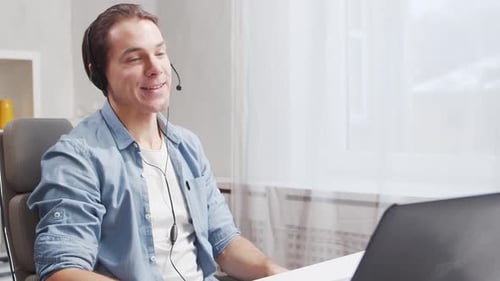Workplace of freelance worker at home office. Young man works using computer.