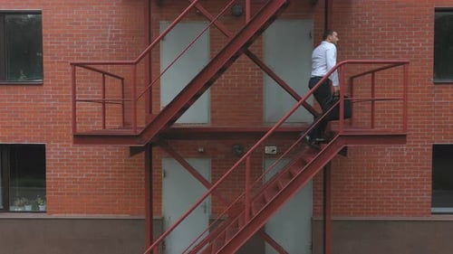 Businessman Climbing Up the Stairs of a Business Centre