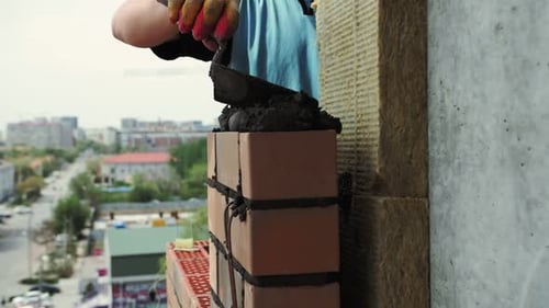 laying bricks of the outer wall of the house