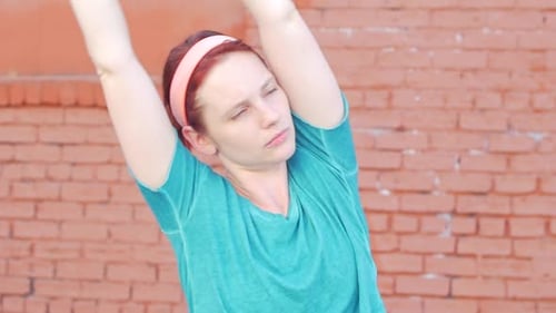 Active Woman Stretching Outside in Urban Environment
