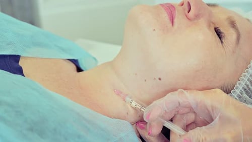 Woman Receiving Injection on Neck in Medical Setting