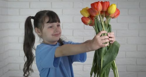 Girl Holding Bouquet of Tulips Indoors