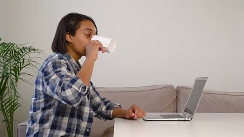 Woman Talking on Laptop in Home Setting