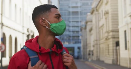 Mixed race man wearing face mask in the street