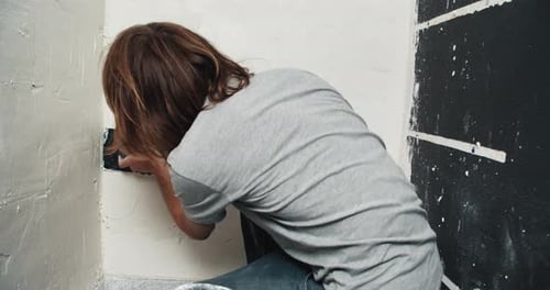 Close Up Young Man Plasters Wall with Spatula and Applies Cement Mix Solution