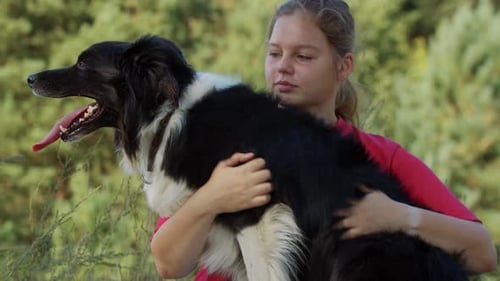 Woman Tenderly Hugging her Dog in Nature
