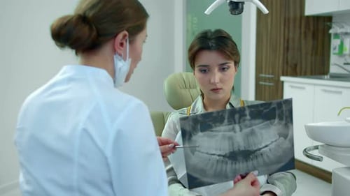 Dentist Shows To Young Girl Her Teeth on X-ray