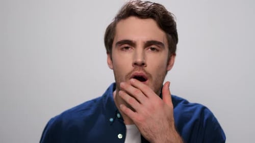 Surprised Man Looking at Camera in Studio. Handsome Guy with Wow Expression