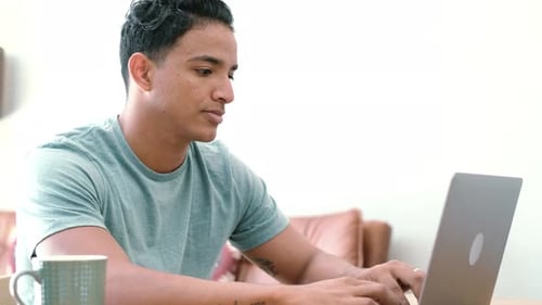 Black young man work at home with modern laptop computer in free office lifestyle smart working