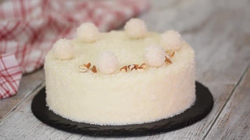 Coconut Cake Decorated with Almonds and Truffle Balls