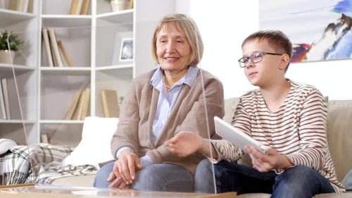 Old Lady and Teenager Using Gadgets