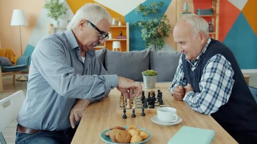 Senior Men Playing Chess and Bonding Indoors