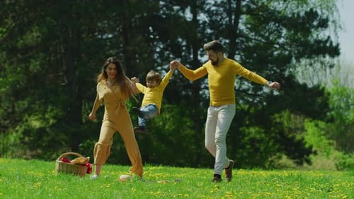 Happy Family Playing in a Spring Meadow