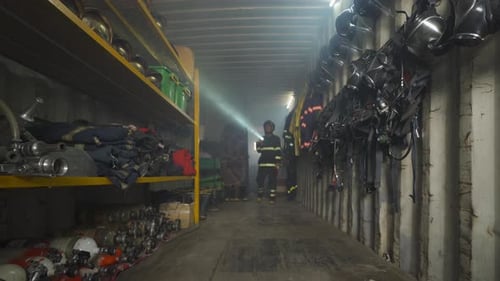 Firefighter with Gear Walking in Fire Station