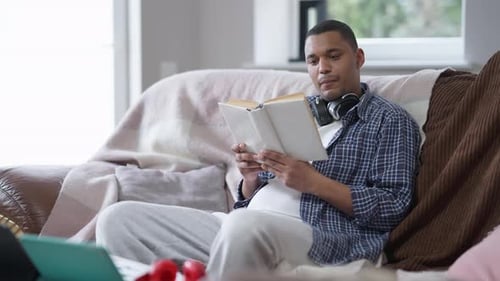 Man Relaxing at Home Reading a Book