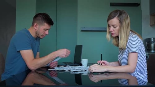 Man and Woman Reviewing Documents at Table