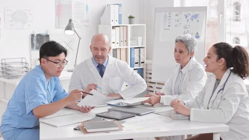 Medical Team Collaborates at Bright Office Table