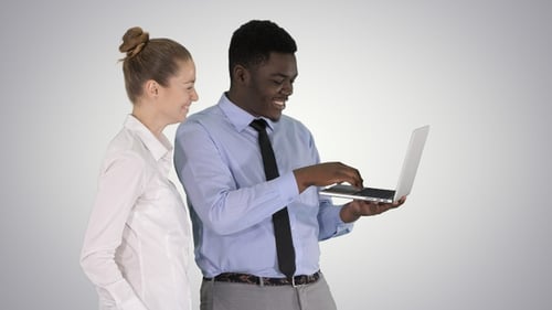 Colleagues Discussing Project on Laptop in Office