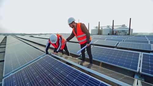 Engineers checking solar panels