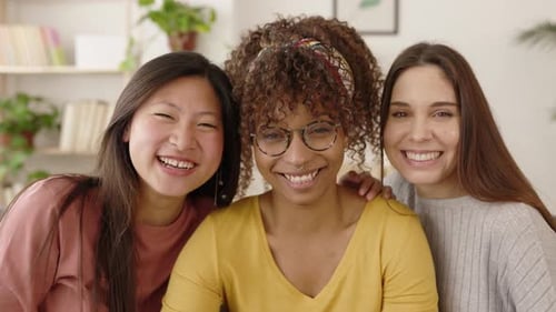 Three Friends Smiling Together Indoors