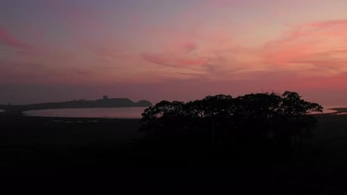 Flying Over Towards the Beach and a View of a Castle Far Ahead