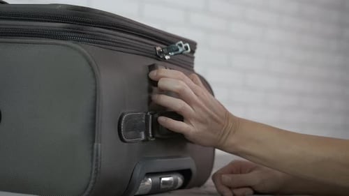 Opening a travel suitcase.