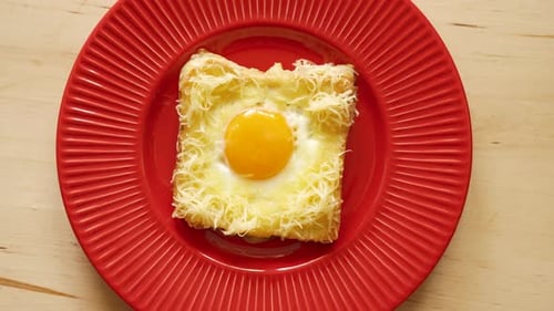 Top View of Toast with Fried Egg and Cheese on Wooden Kitchen Table
