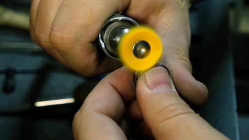 Hands of the Jeweler Polishes Ring on the Polishing Machine