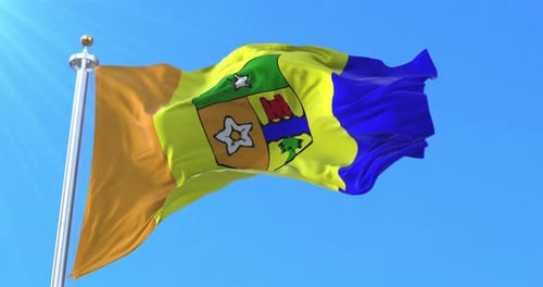 Waving Flag with Coat of Arms Against Clear Blue Sky